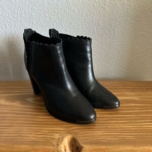 Black booties with scalloped edges